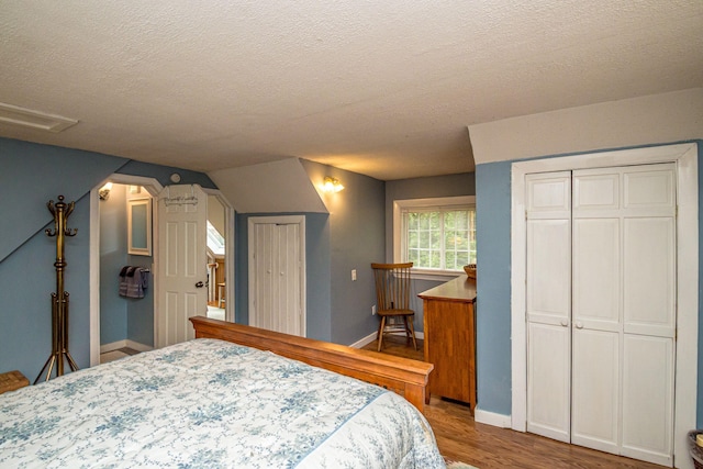 435 Rolling Ridge Rd, Bartlett, NH 03812 - bedroom featuring a textured ceiling, wood finished floors, and attic access