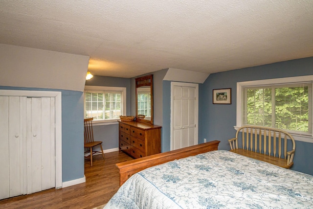 435 Rolling Ridge Rd, Bartlett, NH 03812 - bedroom featuring wood finished floors, a textured ceiling, and multiple windows