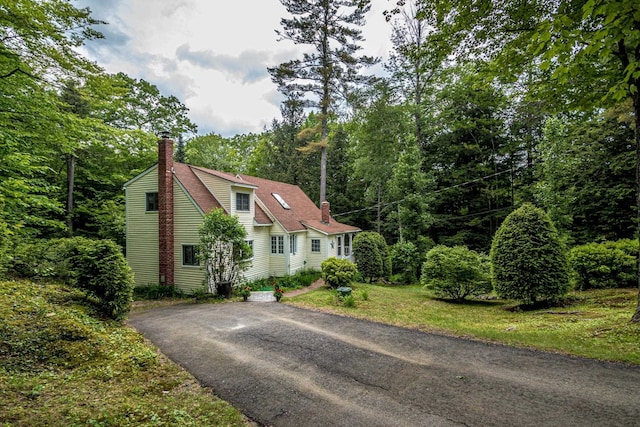 435 Rolling Ridge Rd, Bartlett, NH 03812 - view of front of home with a chimney, driveway, and a view of trees