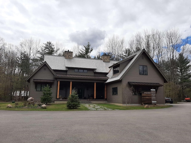 435 Rolling Ridge Rd, Bartlett, NH 03812 - view of front of home featuring a porch, a chimney, a standing seam roof, and a metal roof