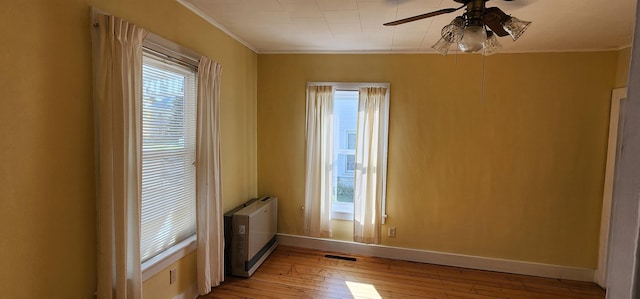 7-9 Elm St, Waterbury, VT 05676 - spare room with ceiling fan, light wood-style floors, and ornamental molding
