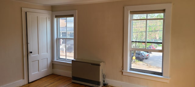 7-9 Elm St, Waterbury, VT 05676 - detailed view of heating unit, wood finished floors, and ornamental molding