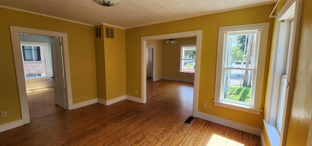 7-9 Elm St, Waterbury, VT 05676 - empty room with hardwood / wood-style flooring, plenty of natural light, and ornamental molding