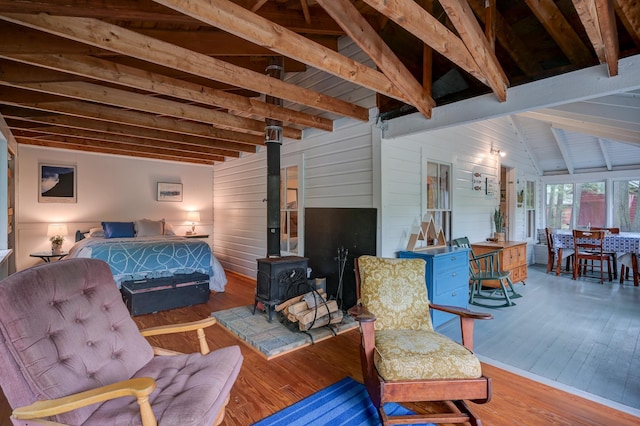 28 Brook Ln, Conway, NH 03818 - bedroom with a wood stove, wood-type flooring, and wooden walls
