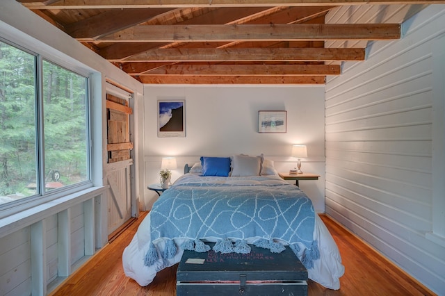 28 Brook Ln, Conway, NH 03818 - bedroom with wood finished floors, wooden walls, and beamed ceiling
