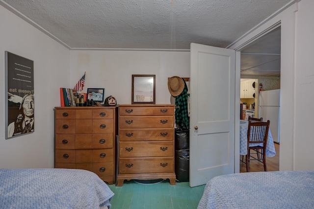 28 Brook Ln, Conway, NH 03818 - bedroom featuring freestanding refrigerator, wood finished floors, and a textured ceiling
