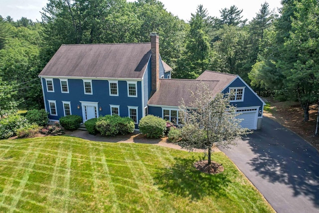 48 Cider Mill Rd, Bedford, NH 03110 - colonial house featuring driveway, a chimney, a front lawn, and an attached garage