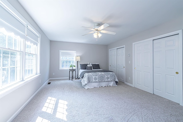 48 Cider Mill Rd, Bedford, NH 03110 - bedroom with multiple closets, carpet flooring, and a ceiling fan
