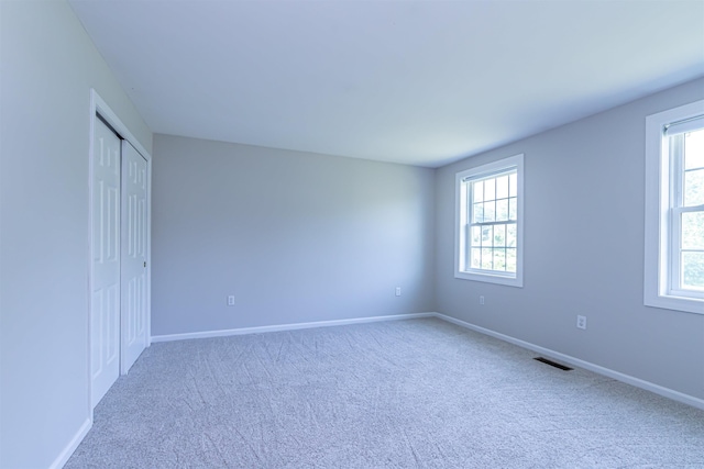 48 Cider Mill Rd, Bedford, NH 03110 - unfurnished bedroom with multiple windows, carpet, and a closet