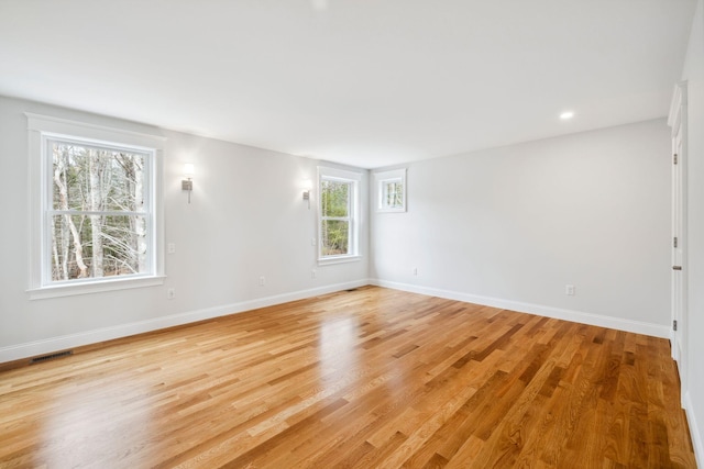 131 Exeter Rd, North Hampton, NH 03862 - empty room with plenty of natural light and light wood-style floors