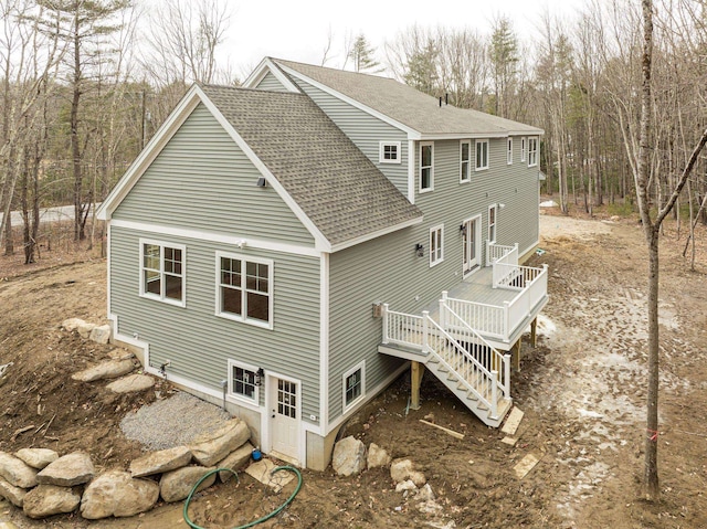131 Exeter Rd, North Hampton, NH 03862 - back of house featuring roof with shingles, a deck, and stairway
