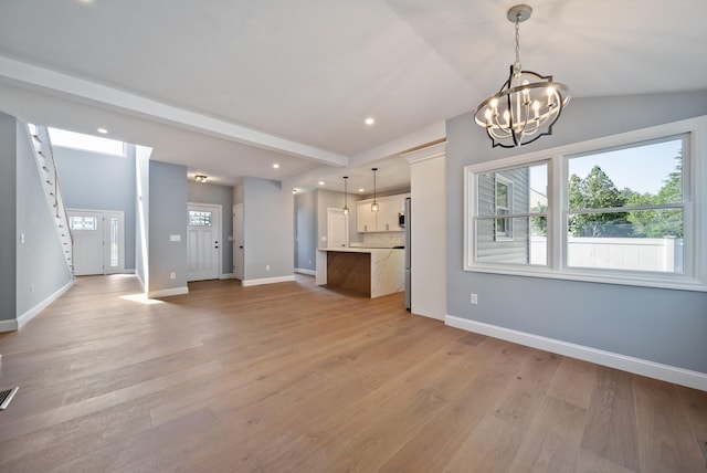 13 Raven St, Nashua, NH 03060 - unfurnished living room with light wood-style floors, a chandelier, recessed lighting, and vaulted ceiling