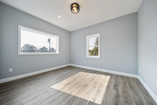 13 Raven St, Nashua, NH 03060 - empty room featuring healthy amount of natural light and wood finished floors