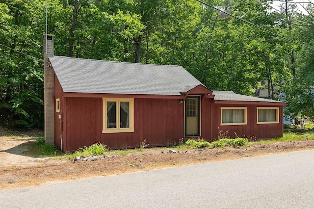 11 Dearborn Rd, Wakefield, NH 03830 - view of front facade with a shingled roof and a chimney