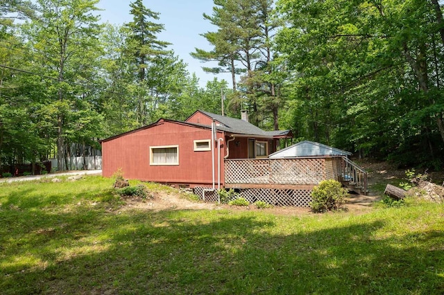 11 Dearborn Rd, Wakefield, NH 03830 - back of property featuring a deck, a yard, and a chimney