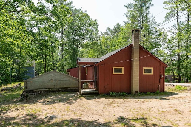 11 Dearborn Rd, Wakefield, NH 03830 - rear view of property featuring a chimney and view of scattered trees