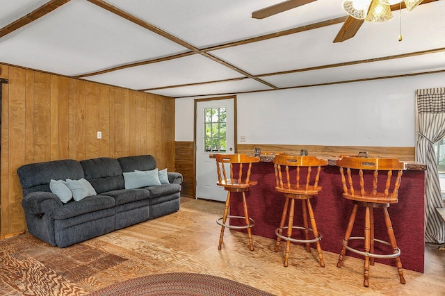 11 Dearborn Rd, Wakefield, NH 03830 - living area with wooden walls, a dry bar, wood finished floors, ceiling fan, and wainscoting