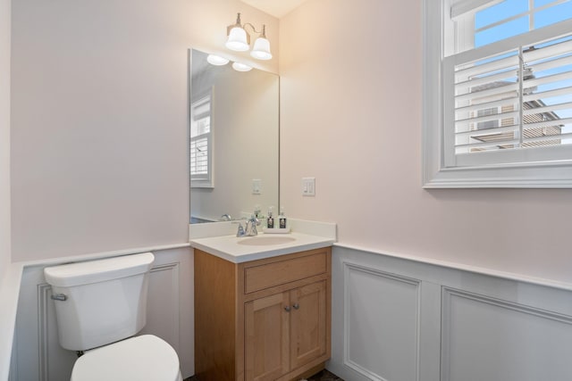5 Fellows Ave, Hampton, NH 03842 - bathroom with vanity, a wainscoted wall, and a decorative wall