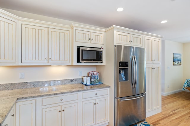5 Fellows Ave, Hampton, NH 03842 - kitchen with stainless steel appliances, light wood finished floors, light stone countertops, and recessed lighting