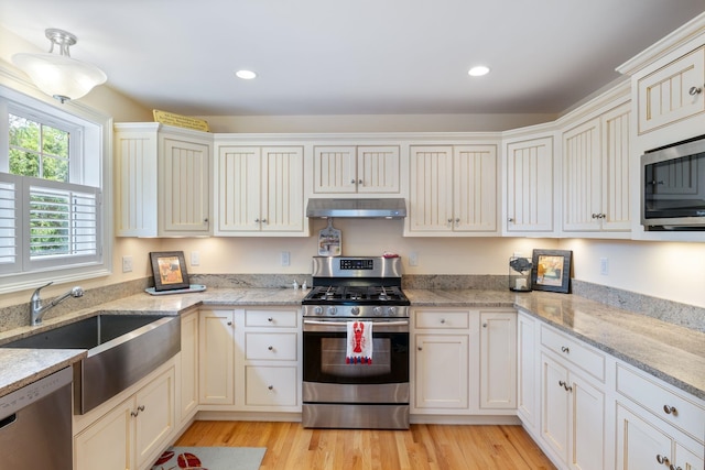 5 Fellows Ave, Hampton, NH 03842 - kitchen featuring appliances with stainless steel finishes, under cabinet range hood, recessed lighting, light wood-type flooring, and light stone countertops