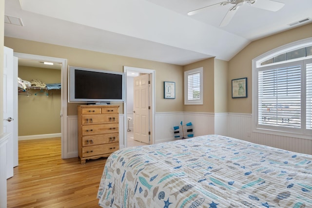 5 Fellows Ave, Hampton, NH 03842 - bedroom with light wood-type flooring, wainscoting, a walk in closet, lofted ceiling, and a closet