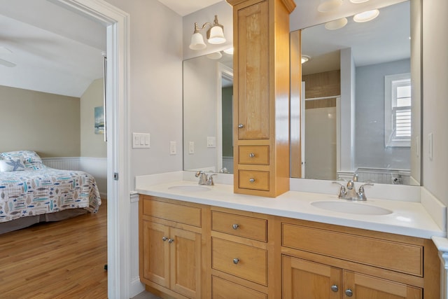 5 Fellows Ave, Hampton, NH 03842 - ensuite bathroom with double vanity, a shower with door, wood finished floors, and wainscoting