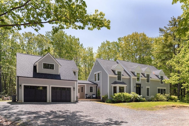 137 Wildes District Rd, Kennebunkport, ME 04046 - view of front of home with driveway, a garage, a shingled roof, and a wooden deck