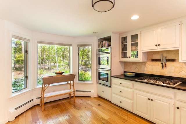 137 Wildes District Rd, Kennebunkport, ME 04046 - kitchen featuring appliances with stainless steel finishes, dark countertops, light wood-style flooring, decorative backsplash, and recessed lighting
