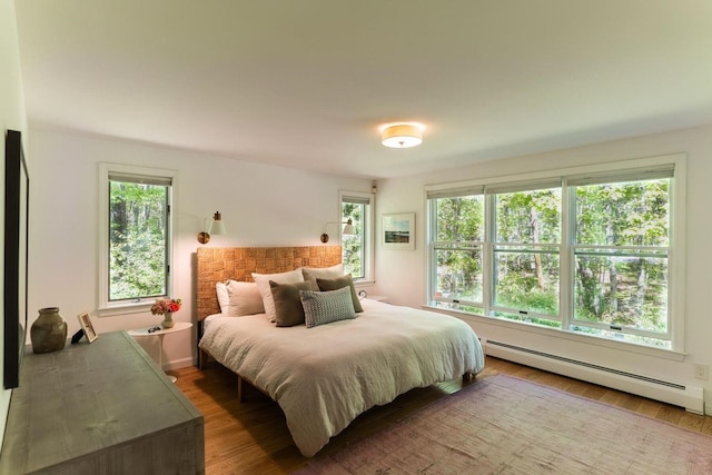 137 Wildes District Rd, Kennebunkport, ME 04046 - bedroom featuring a baseboard heating unit, multiple windows, and wood finished floors