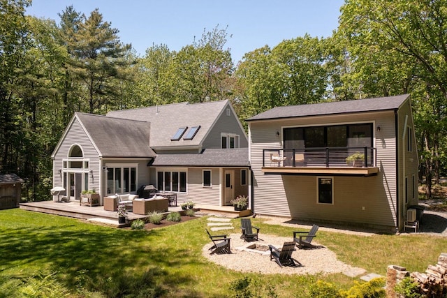 137 Wildes District Rd, Kennebunkport, ME 04046 - rear view of property featuring an outdoor living space with a fire pit, a balcony, a lawn, roof with shingles, and a deck
