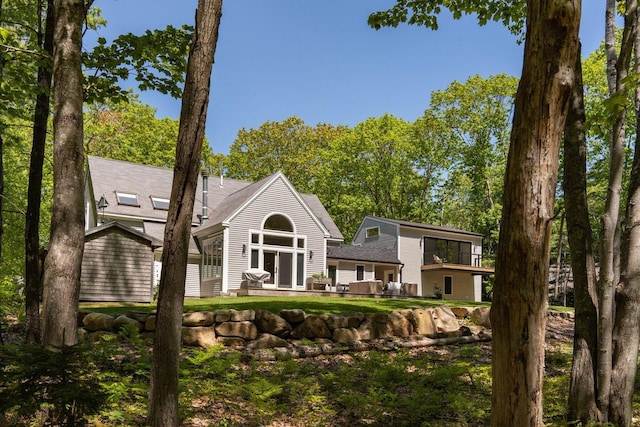 137 Wildes District Rd, Kennebunkport, ME 04046 - back of property featuring a patio area and a shingled roof