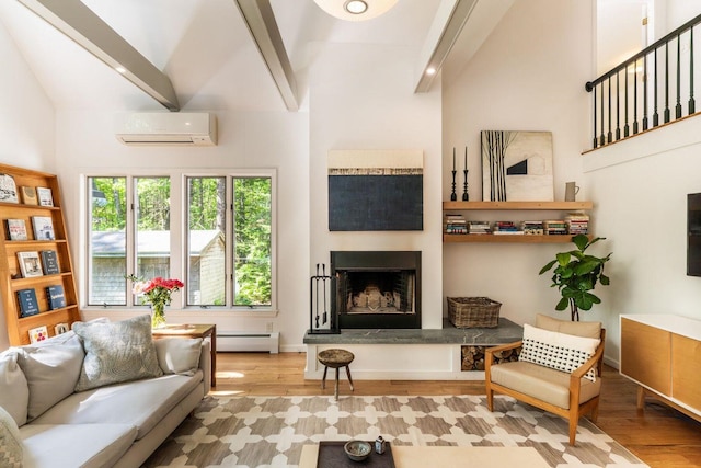 137 Wildes District Rd, Kennebunkport, ME 04046 - living area featuring a wall mounted air conditioner, a baseboard radiator, wood finished floors, and a fireplace with raised hearth