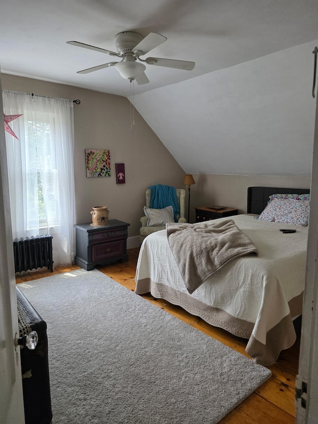 104 Middle St, Lancaster, NH 03584 - bedroom featuring radiator heating unit, light wood-style flooring, vaulted ceiling, and ceiling fan