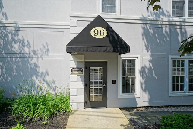 96 River Rd Unit 205, Manchester, NH 03104 - doorway to property featuring stucco siding