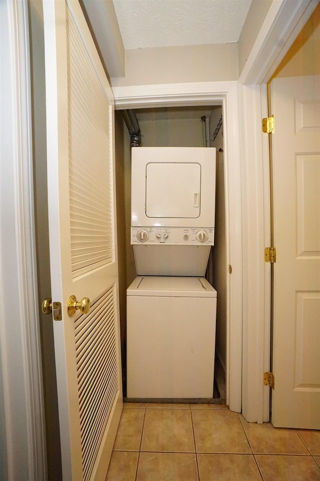 96 River Rd Unit 205, Manchester, NH 03104 - laundry room with stacked washer / dryer and light tile patterned flooring