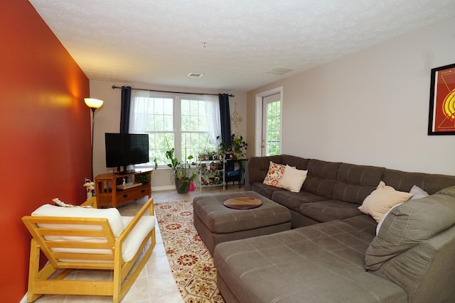 96 River Rd Unit 205, Manchester, NH 03104 - tiled living area featuring a textured ceiling and baseboards
