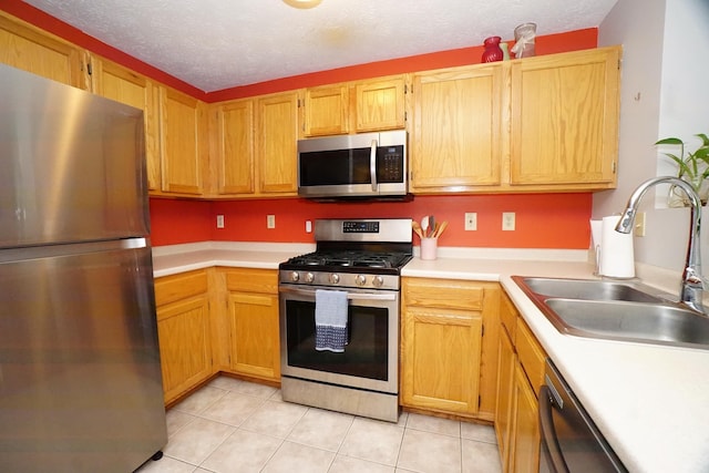 96 River Rd Unit 205, Manchester, NH 03104 - kitchen with stainless steel appliances, light countertops, light tile patterned flooring, and a textured ceiling