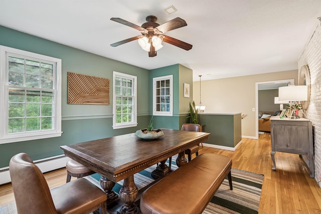 8 Willow Spring Ln, Hanover, NH 03755 - dining area with light wood finished floors, healthy amount of natural light, a ceiling fan, and brick wall