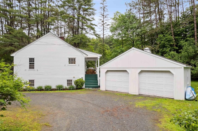 8 Willow Spring Ln, Hanover, NH 03755 - view of side of home featuring a chimney, an outbuilding, a detached garage, and view of scattered trees