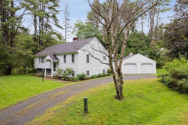 8 Willow Spring Ln, Hanover, NH 03755 - view of front of property with an outdoor structure, a detached garage, a chimney, a front lawn, and roof with shingles