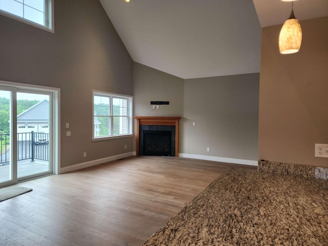 22 John Hardie Way, Chichester, NH 03234 - unfurnished living room featuring high vaulted ceiling, light wood finished floors, healthy amount of natural light, and a fireplace