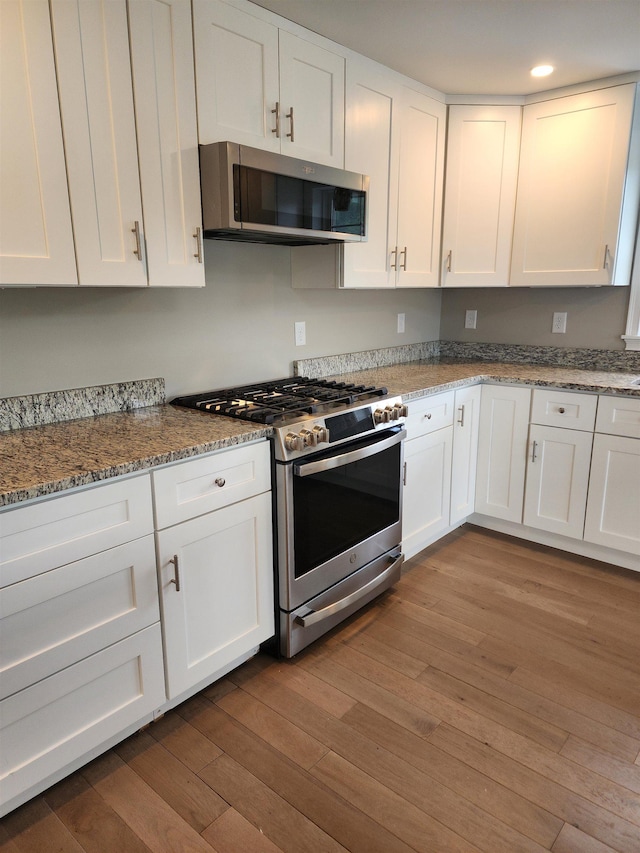 22 John Hardie Way, Chichester, NH 03234 - kitchen featuring stainless steel appliances, white cabinets, hardwood / wood-style flooring, light stone counters, and recessed lighting