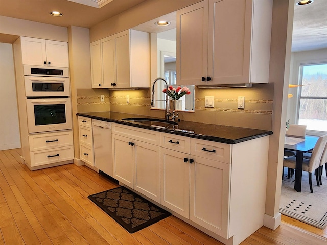 201 Lower Judson Ln, Stowe, VT 05672 - kitchen with white appliances, dark countertops, light wood-style floors, white cabinetry, and recessed lighting