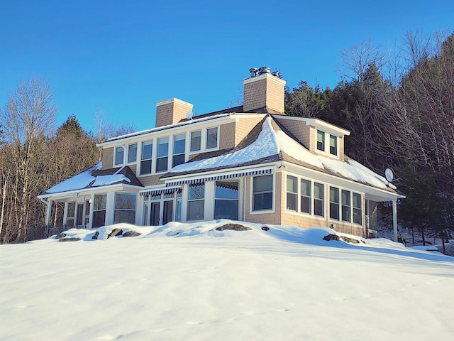 201 Lower Judson Ln, Stowe, VT 05672 - snow covered back of property featuring a chimney