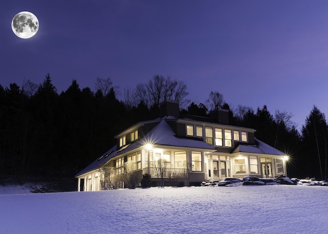 201 Lower Judson Ln, Stowe, VT 05672 - snow covered rear of property with a chimney and a garage