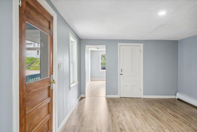 10 Lafountain St, Winooski, VT 05404 - foyer with light wood finished floors, a textured ceiling, baseboard heating, and recessed lighting