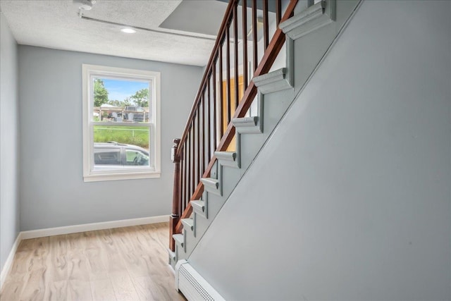 10 Lafountain St, Winooski, VT 05404 - stairway featuring a textured ceiling and wood finished floors