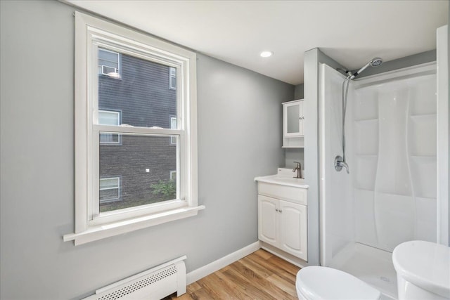 10 Lafountain St, Winooski, VT 05404 - bathroom featuring a baseboard radiator, a shower, wood finished floors, and vanity
