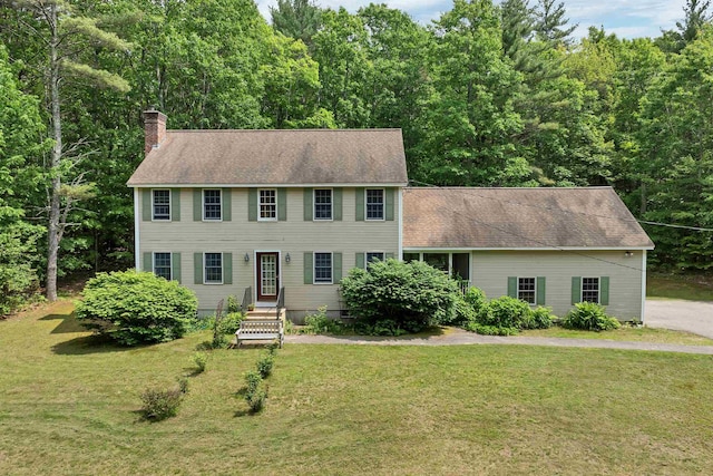 4 June Bug Ln, Wolfeboro, NH 03894 - colonial-style house featuring a chimney, a front lawn, and a shingled roof