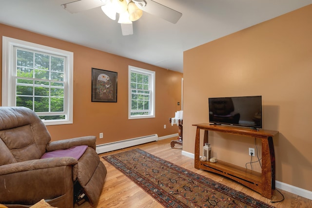 4 June Bug Ln, Wolfeboro, NH 03894 - living room featuring baseboard heating, a ceiling fan, and light wood-style floors